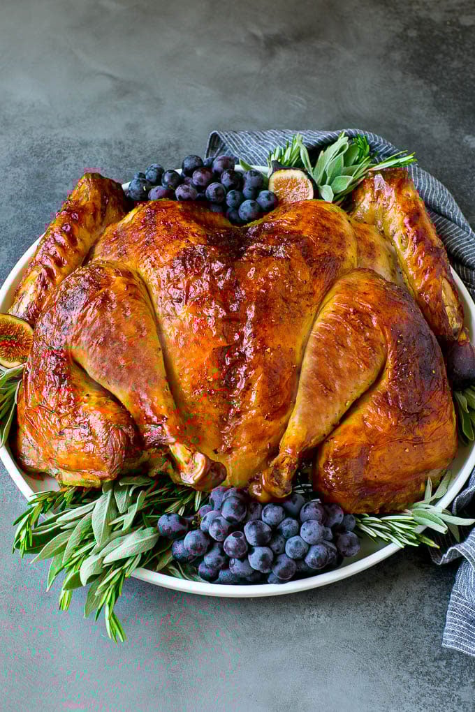 Spatchcock Turkey | Roasted Turkey | Thanksgiving Turkey #turkey #thanksgiving #dinner #fall #christmas #ezlod Spatchcock turkey garnished with grapes and fresh herbs.