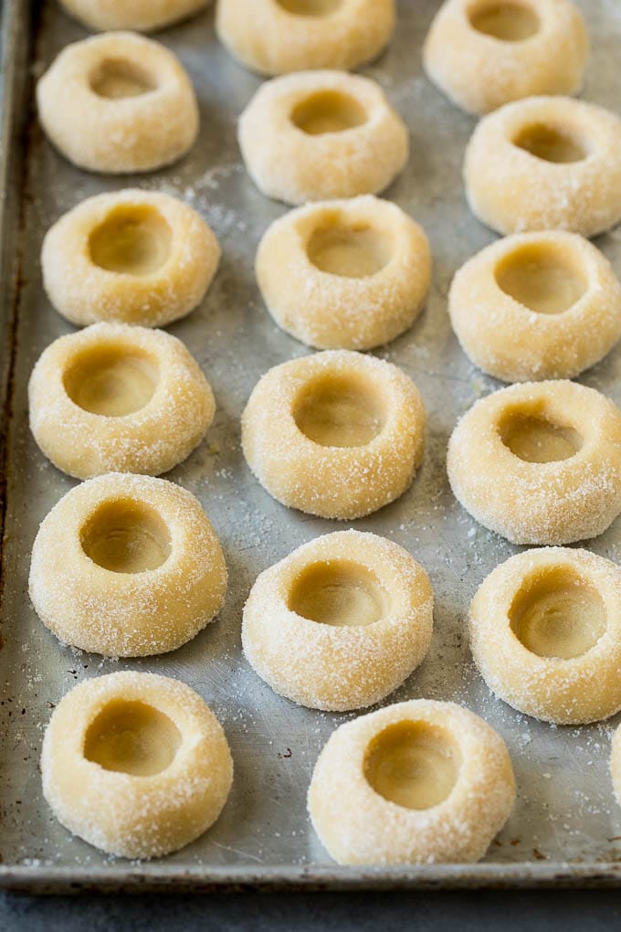 Thumbprint Cookies | Sugar Cookies #cookies #baking #christmas #dessert #ezlod Balls of cookie dough with indentations in them.