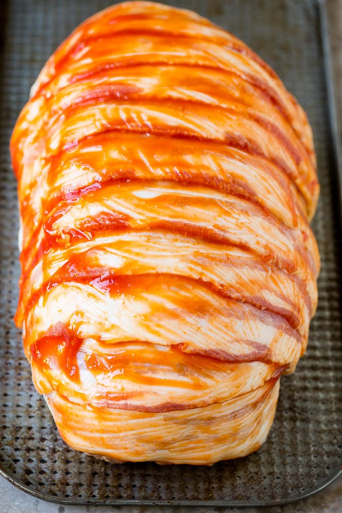 Bacon Wrapped Meatloaf Recipe | Beef Meatloaf #meatloaf #beef #groundbeef #bacon #dinner #ezlod Raw slices of bacon wrapped around a seasoned ground beef loaf.