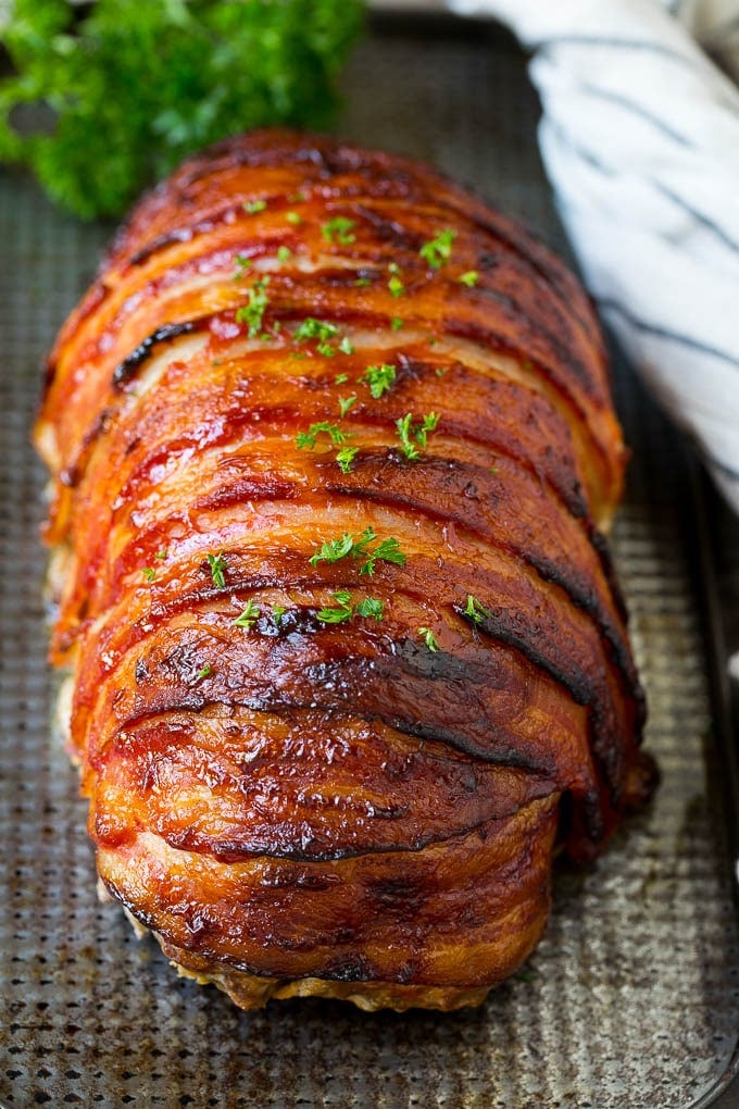 Bacon Wrapped Meatloaf Recipe | Beef Meatloaf #meatloaf #beef #groundbeef #bacon #dinner #ezlod Meatloaf wrapped in slices of bacon and baked, then topped with parsley.