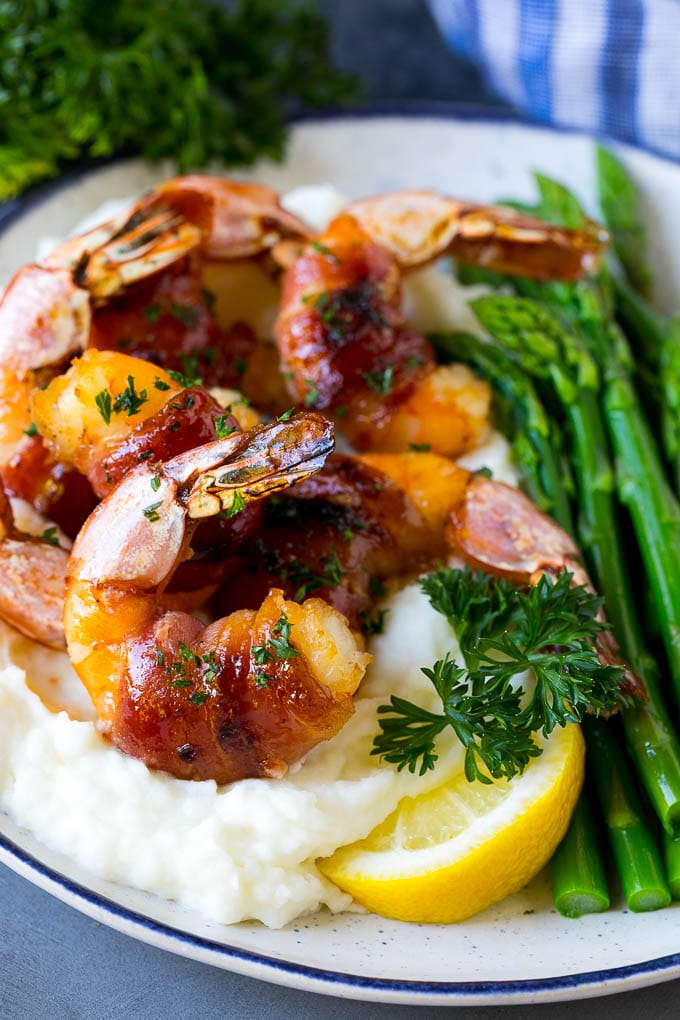 Bacon Wrapped Shrimp Recipe | Bacon Shrimp #shrimp #bacon #appetizer #dinner #ezlod #seafood Bacon wrapped shrimp served over mashed potatoes with green beans.