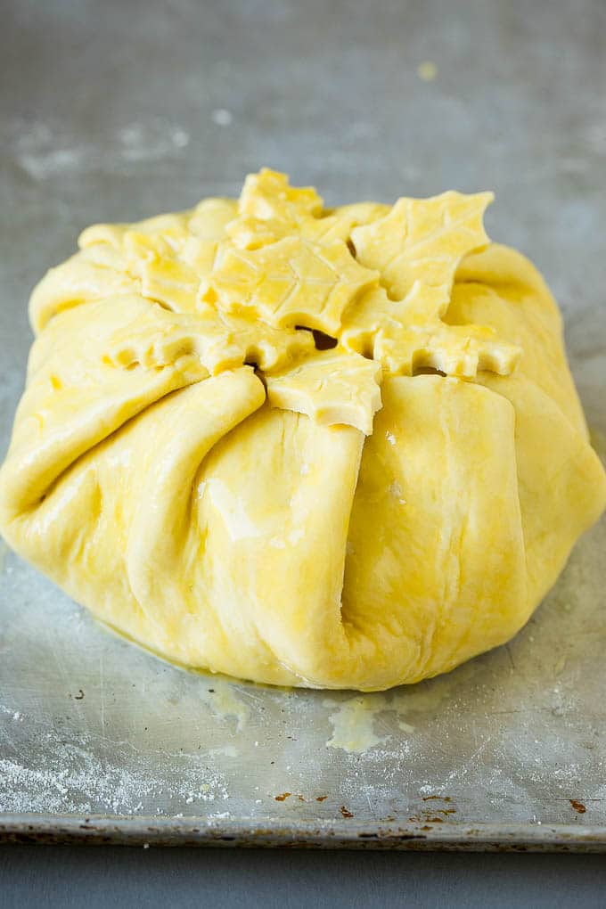 Baked Brie Recipe | Pastry Wrapped Brie #brie #cheese #appetizer #pecans #raspberries #ezlod Cheese wrapped in puff pastry and topped with egg wash.