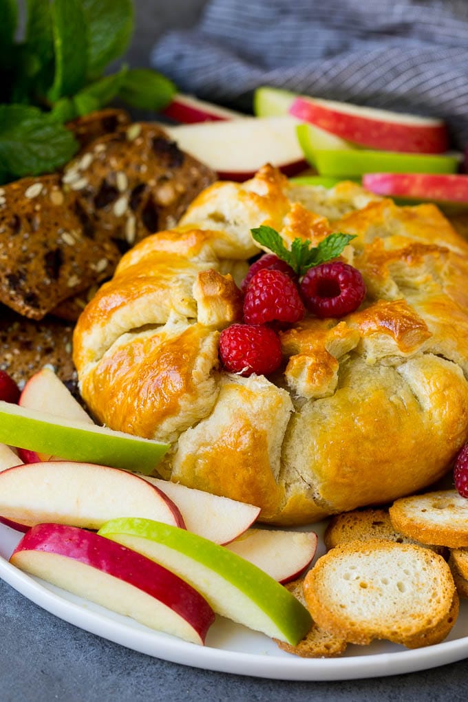 Baked Brie Recipe | Pastry Wrapped Brie #brie #cheese #appetizer #pecans #raspberries #ezlod Brie wrapped in puff pastry, served with apples and crackers.