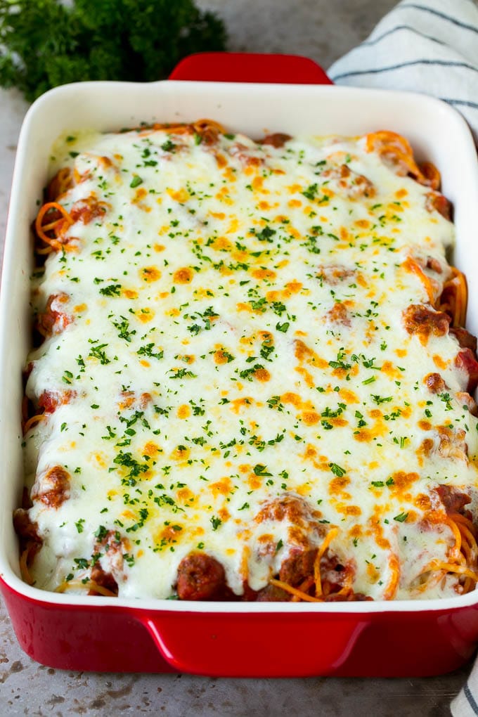 Baked Spaghetti Recipe | Baked Pasta #spaghetti #pasta #cheese #casserole #beef #sausage #dinner #ezlod Spaghetti in a baking dish with melted cheese baked on top.