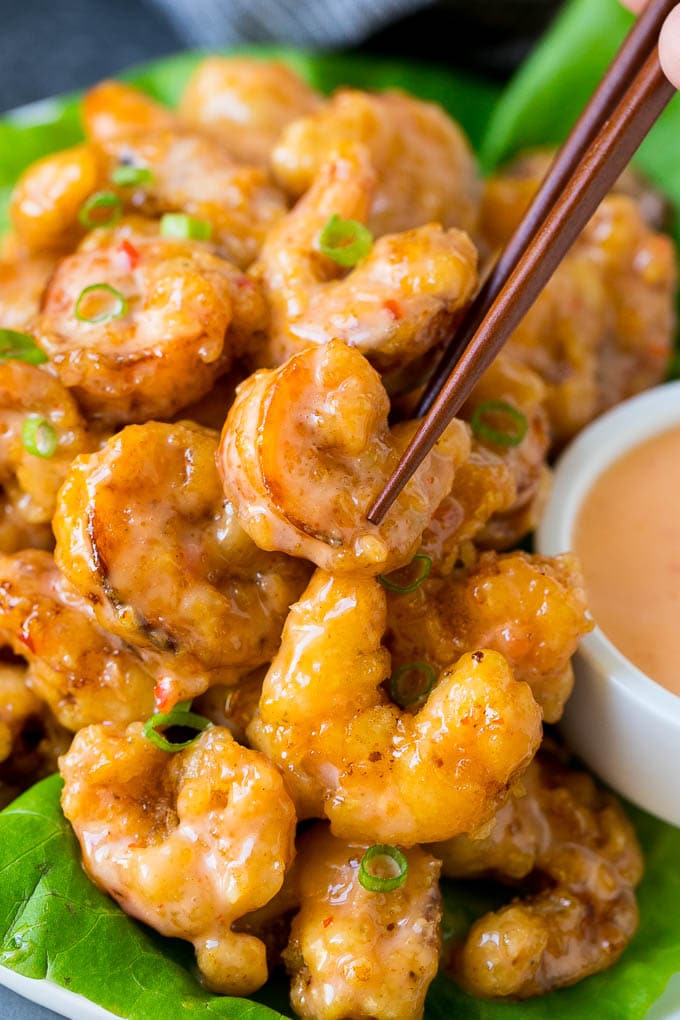 Bang Bang Shrimp Recipe | Fried Shrimp #shrimp #appetizer #dinner #ezlod #copycatrecipe A pair of chopsticks picking up bang bang shrimp.