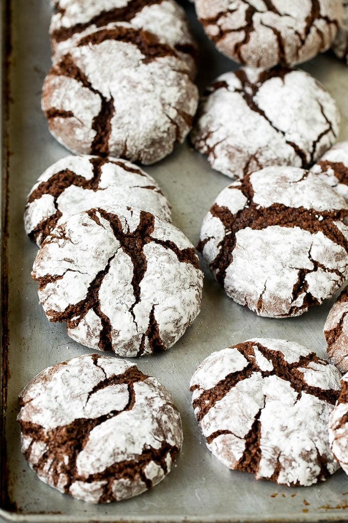 Chocolate Crinkle Cookies Recipe #cookies #chocolate #christmas #dessert #baking #ezlod Crinkle cookies on a sheet pan.