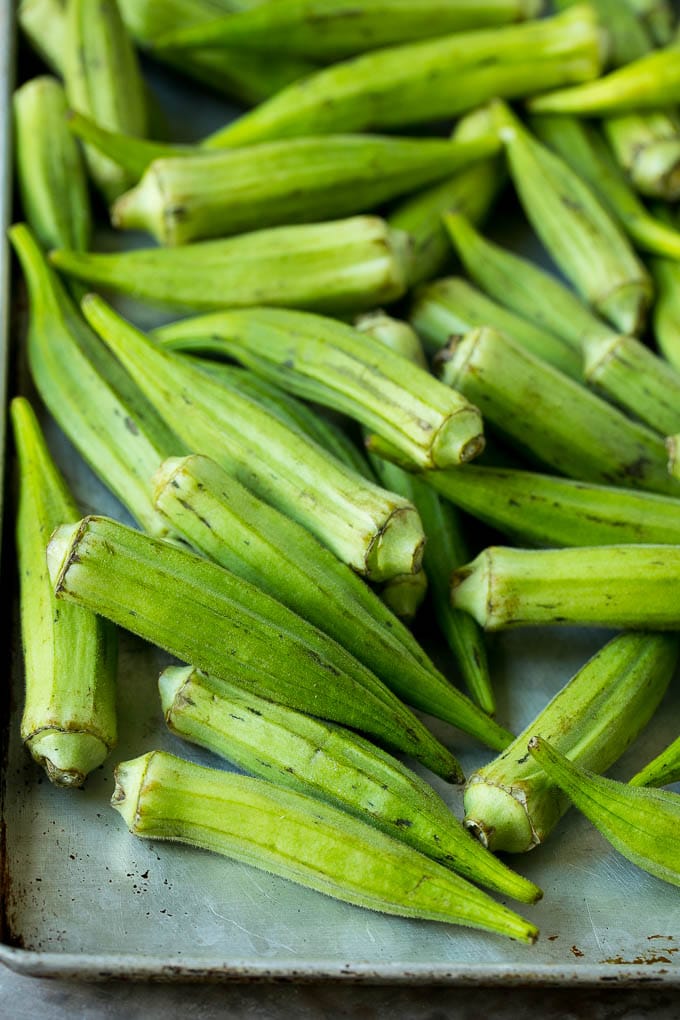 Fried Okra Recipe #okra #appetizer #sidedish #ezlod Okra pods on a sheet pan.