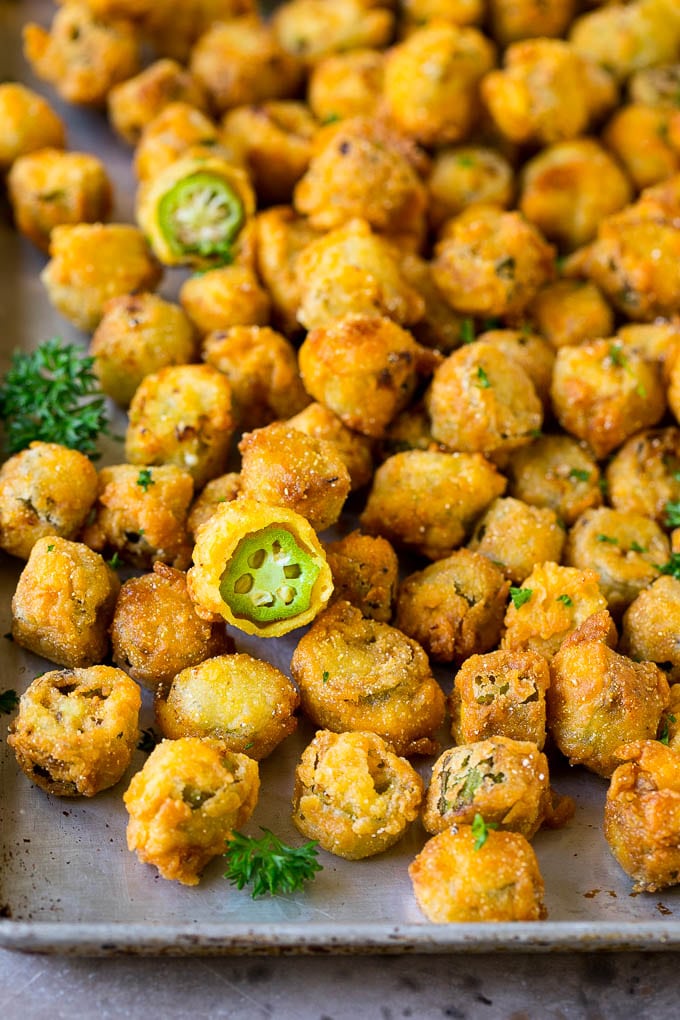 Fried Okra Recipe #okra #appetizer #sidedish #ezlod Fried okra on a sheet pan, garnished with chopped parsley.