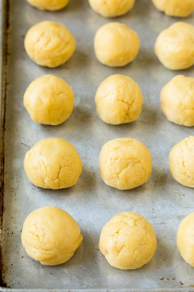 Italian Cookies Recipe | Almond Cookies #cookies #italianfood #frosting #sprinkles #baking #christmas #ezlod Balls of cookie dough on a sheet pan.