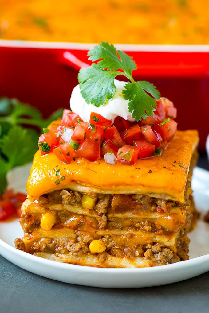 Mexican Lasagna Recipe | Mexican Casserole #mexican #lasagna #groundbeef #beans #dinner #cheese #ezlod A slice of Mexican lasagna made with layers of cheese, tortillas and meat.