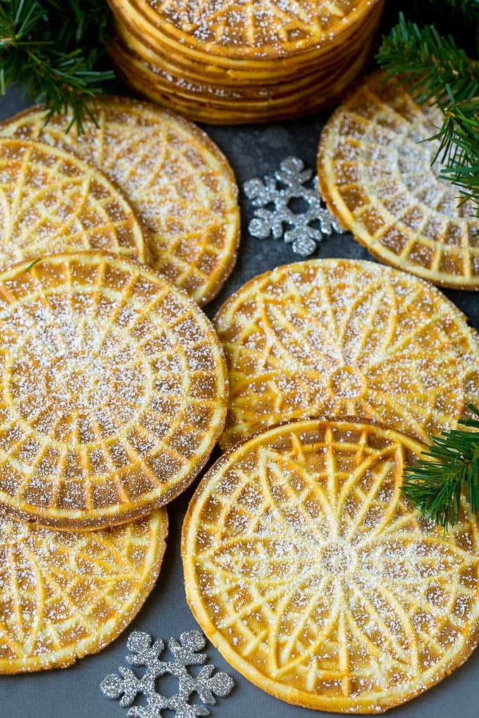 Pizzelle Cookies Recipe #cookies #baking #dessert #christmas #ezlod Pizzelle cookies cooked to golden brown and coated in powdered sugar.
