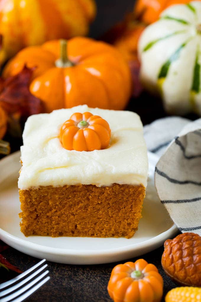 Pumpkin Cake Recipe | Pumpkin Spice Cake #cake #pumpkin #dessert #baking #fall #thanksgiving #ezlod A slice of pumpkin cake topped with cream cheese frosting.