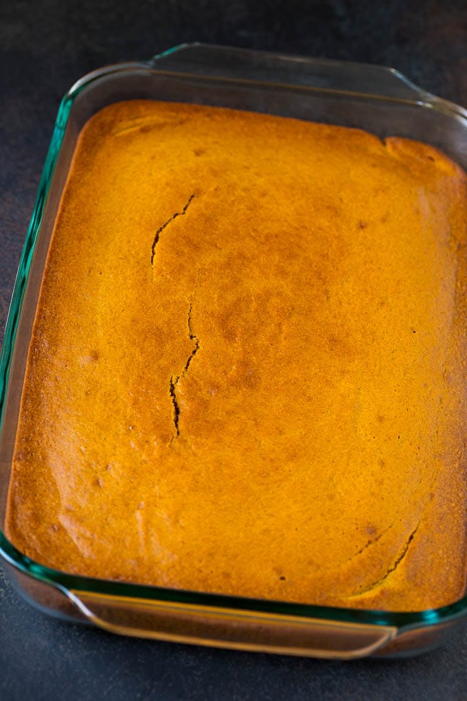 Pumpkin Cake Recipe | Pumpkin Spice Cake #cake #pumpkin #dessert #baking #fall #thanksgiving #ezlod A baked base in a glass dish ready for frosting.