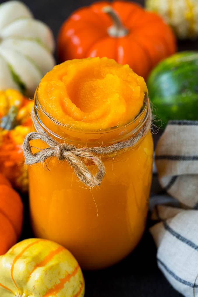 Pumpkin Puree Recipe #pumpkin #baking #fall #thanksgiving #ezlod A jar of pumpkin puree surrounded by fall produce.
