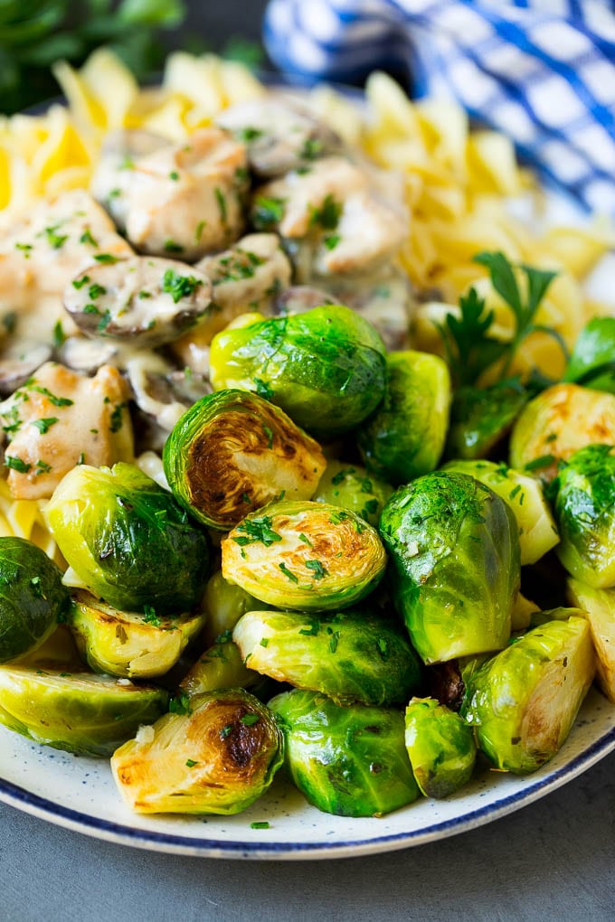 Sauteed Brussels Sprouts Recipe | Brussels Sprouts Side Dish #brusselssprouts #sprouts #veggies #sidedish #garlic #vegetarian #dinner #ezlod Sauteed brussels sprouts served alongside chicken and noodles.