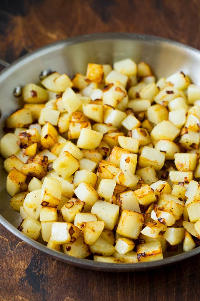 Corned Beef Hash Recipe #hash #cornedbeef #stpatricksday #breakfast #brunch #potatoes #ezlod Sauteed potatoes in a skillet.