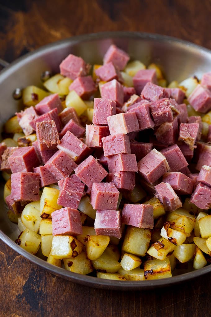 Corned Beef Hash Recipe #hash #cornedbeef #stpatricksday #breakfast #brunch #potatoes #ezlod Cubed corn beef on top of cooked potatoes.