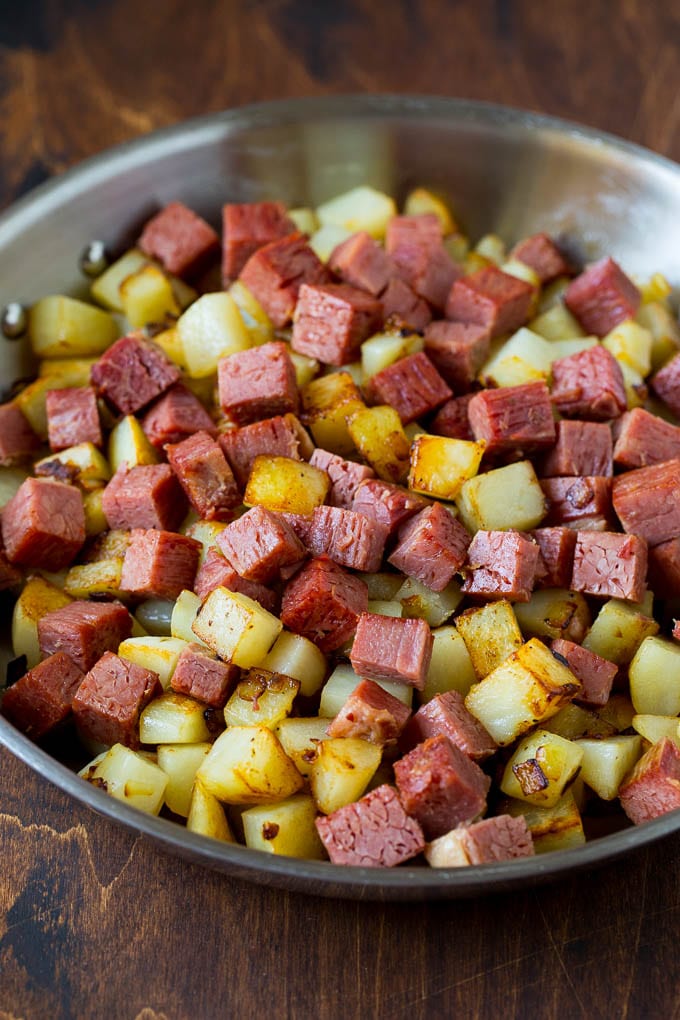 Corned Beef Hash Recipe #hash #cornedbeef #stpatricksday #breakfast #brunch #potatoes #ezlod Corned beef and potatoes cooked together in a pan.