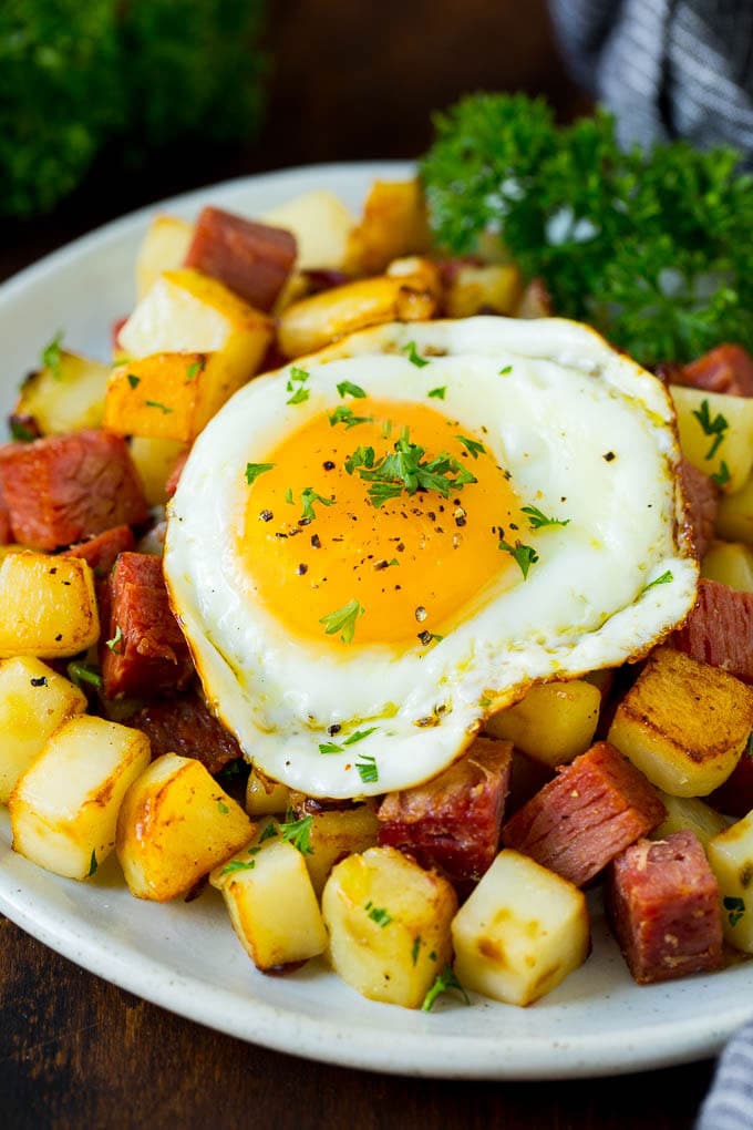 Corned Beef Hash Recipe #hash #cornedbeef #stpatricksday #breakfast #brunch #potatoes #ezlod A plate of corned beef hash topped with a fried egg.