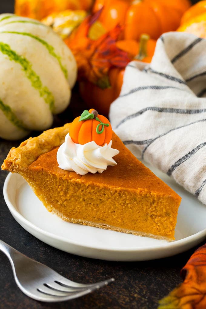 Homemade Pumpkin Pie Recipe | Pumpkin Pie #pie #pumpkin #baking #thanksgiving #fall #dessert #ezlod A slice of homemade pumpkin pie topped with whipped cream and a candy pumpkin.