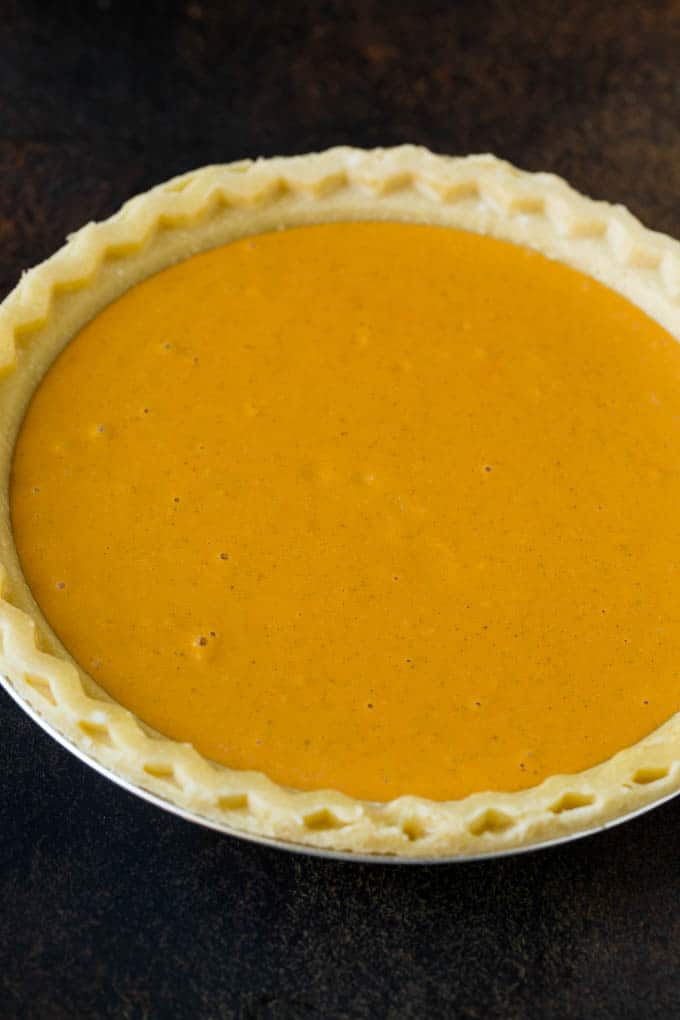 Homemade Pumpkin Pie Recipe | Pumpkin Pie #pie #pumpkin #baking #thanksgiving #fall #dessert #ezlod Pie filling inside a pie crust.
