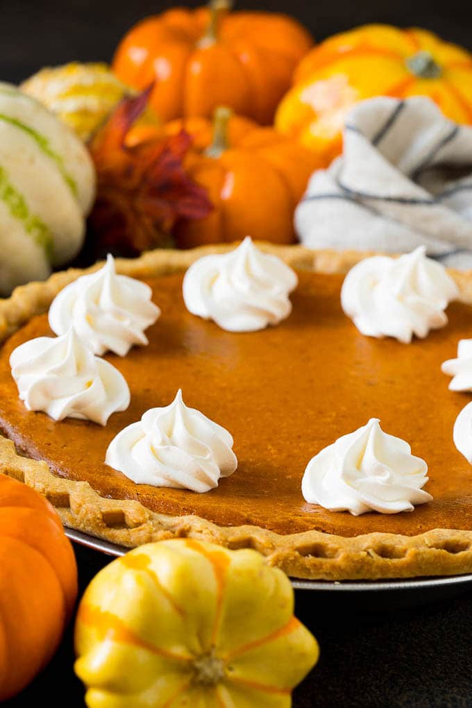 Homemade Pumpkin Pie Recipe | Pumpkin Pie #pie #pumpkin #baking #thanksgiving #fall #dessert #ezlod Homemade pumpin pie topped with rosettes of whipped cream.