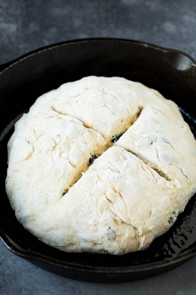 Irish Soda Bread Recipe #bread #baking #stpatricksday #sidedish #ezlod A shaped loaf of soda bread in a skillet.