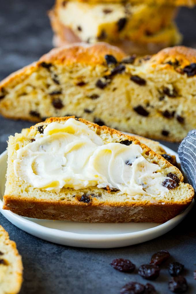 Irish Soda Bread Recipe #bread #baking #stpatricksday #sidedish #ezlod A slice of Irish soda bread with butter spread on it.