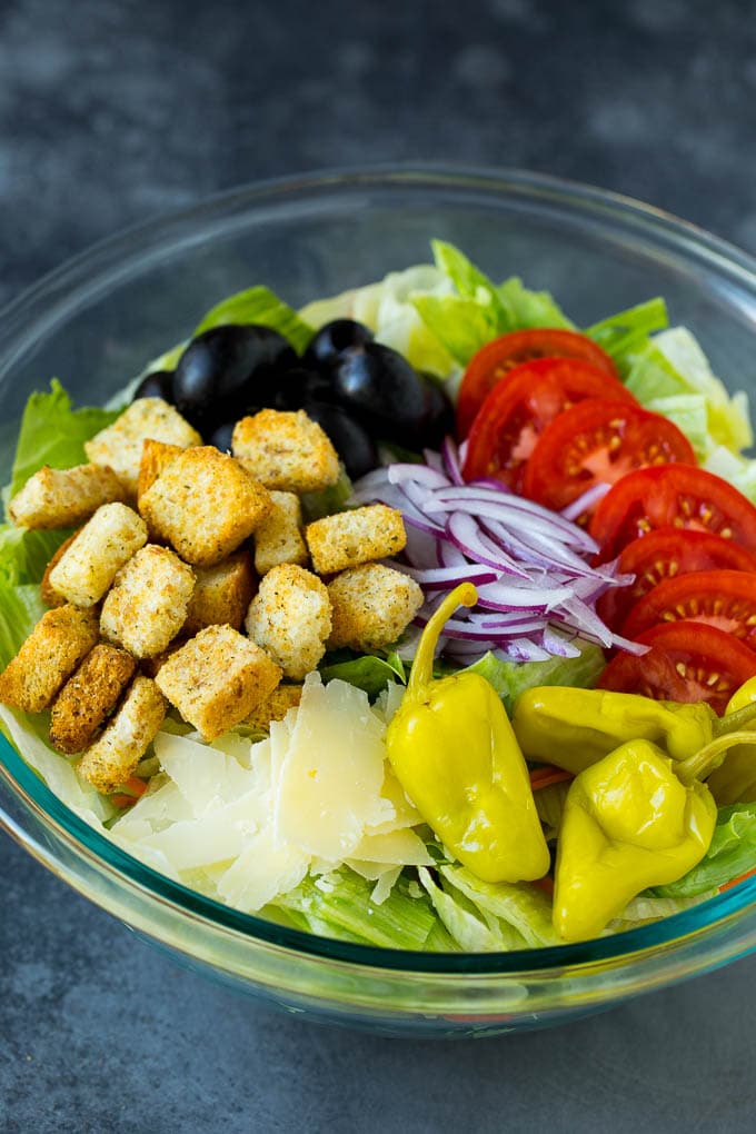 Olive Garden Salad Recipe | Italian Salad #salad #lettuce #olives #sidedish #dinner #ezlod Lettuce, vegetables, olives and croutons in a bowl.