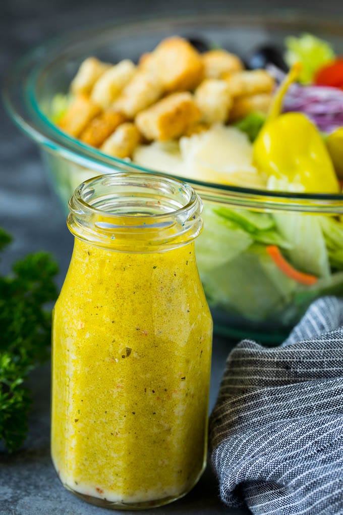 Olive Garden Salad Recipe | Italian Salad #salad #lettuce #olives #sidedish #dinner #ezlod A bottle of homemade salad dressing.