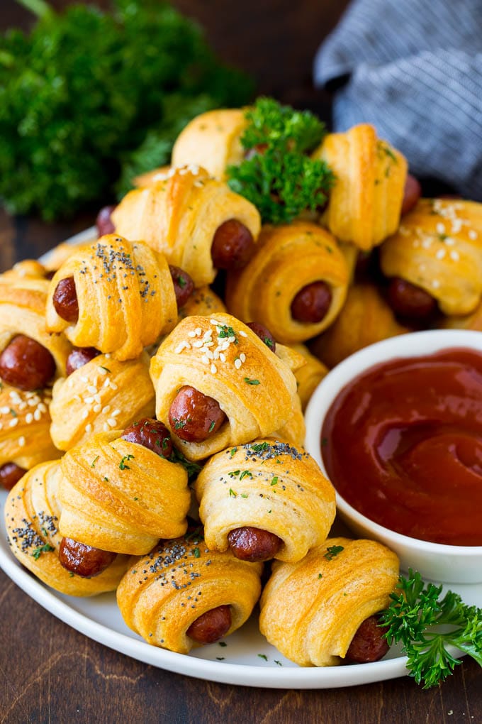 Pigs in a Blanket Recipe #hotdogs #appetizer #snack #comfortfood #ezlod A plate of pigs in a blanket served with ketchup.
