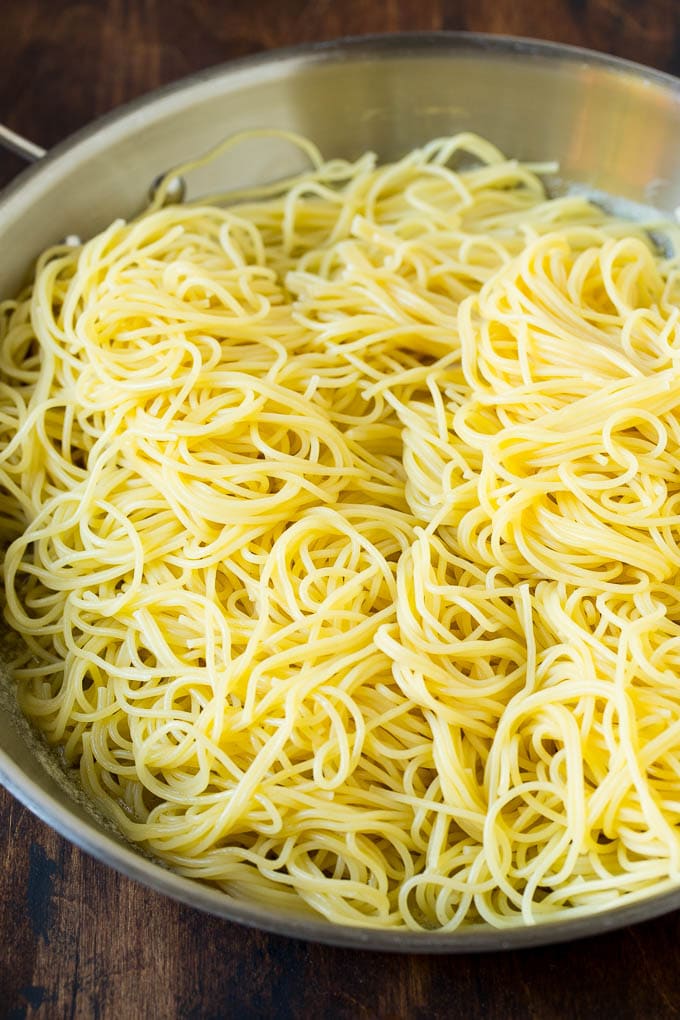 Garlic and Herb Angel Hair Pasta #pasta #garlic #sidedish #dinner #ezlod Pasta in a pan with garlic and butter.