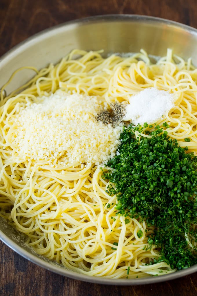 Garlic and Herb Angel Hair Pasta #pasta #garlic #sidedish #dinner #ezlod Pasta topped with herbs, cheese, salt and pepper.
