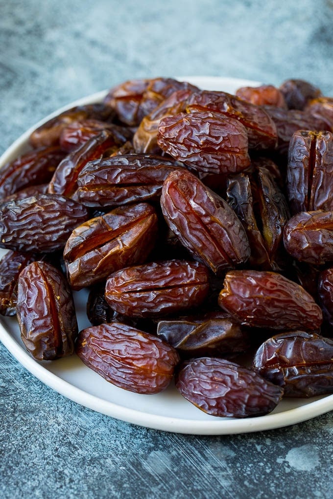 Bacon Wrapped Dates #appetizer #bacon #dates #cheese #ezlod Dates split open on a plate.