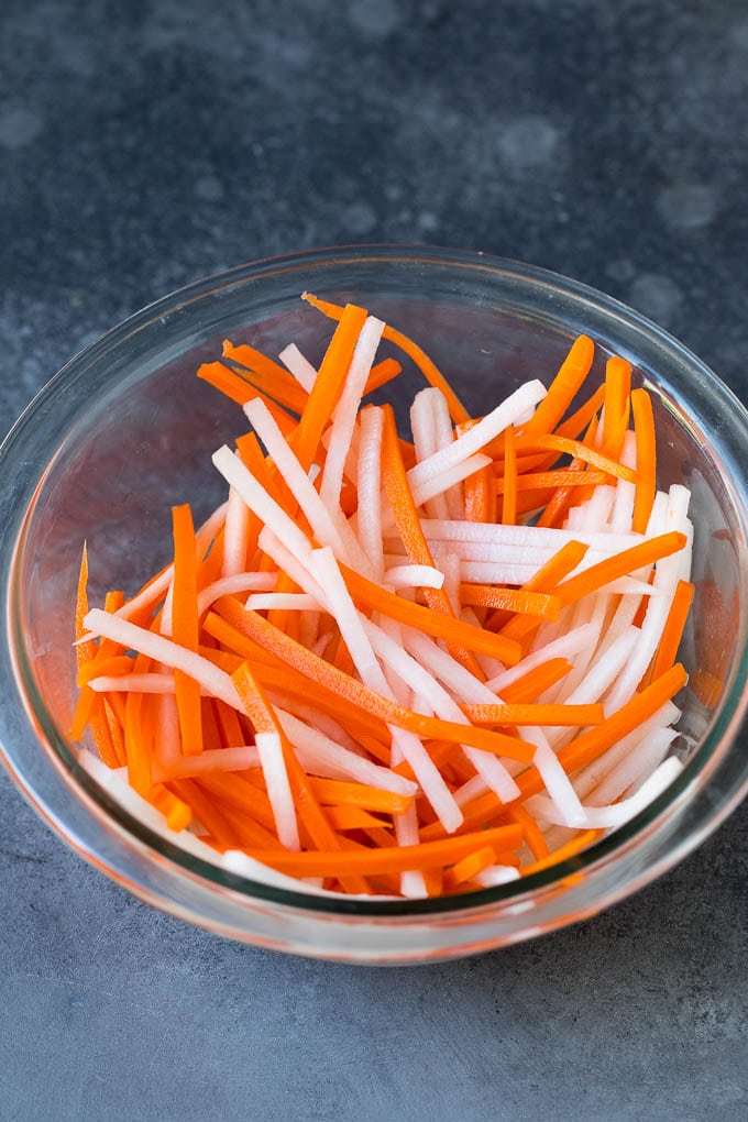 Bahn Mi Sandwich Recipe #sandwich #pork #lunch #dinner #ezlod Shredded carrots and daikon radish in a bowl.