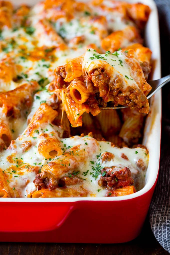 Baked Rigatoni Pasta #pasta #dinner #italianfood #groundbeef #ezlod #casserole A spoon serving up a portion of baked rigatoni pasta.