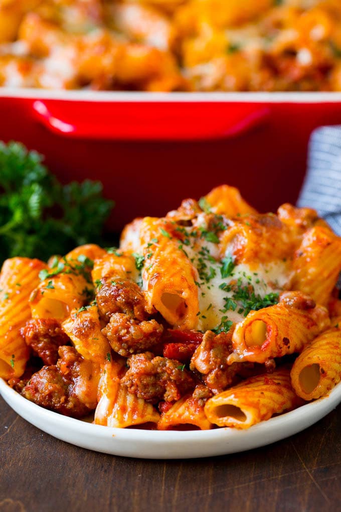 Baked Rigatoni Pasta #pasta #dinner #italianfood #groundbeef #ezlod #casserole A plate of baked rigatoni topped with melted cheese.