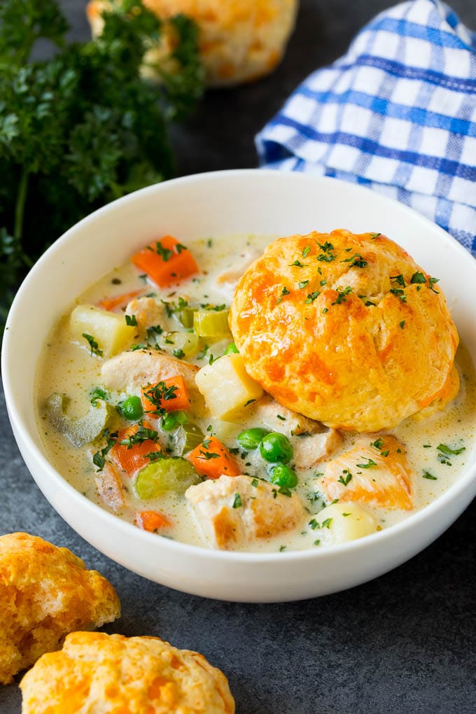 Chicken Pot Pie Soup Recipe | Chicken Soup #soup #chicken #dinner #comfortfood #ezlod A bowl of chicken pot pie soup with a biscuit on top.