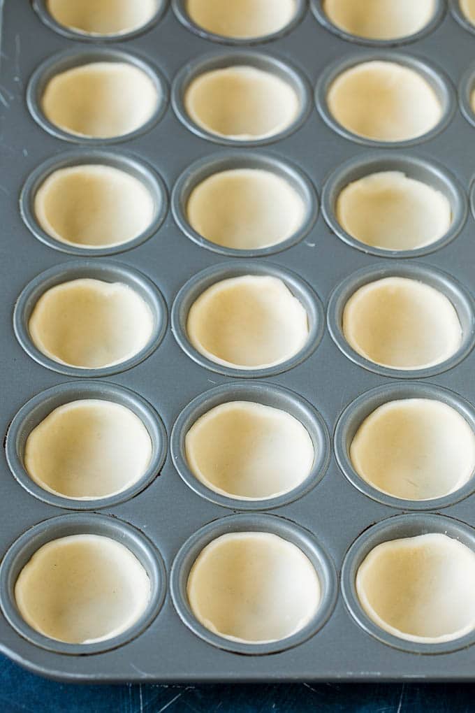 Mini Quiche Recipe #eggs #breakfast #brunch #appetizer #ezlod Pie crust rounds pressed into muffin tins.