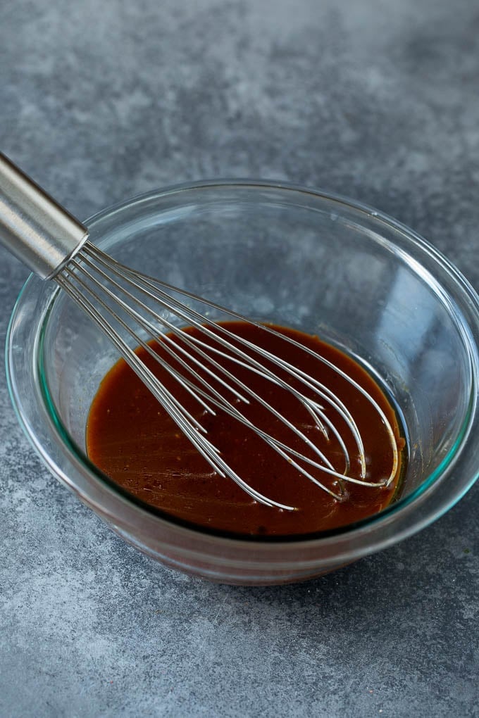 Asian Slaw Recipe #salad #slaw #sidedish #ezlod A bowl of homemade sesame ginger dressing.
