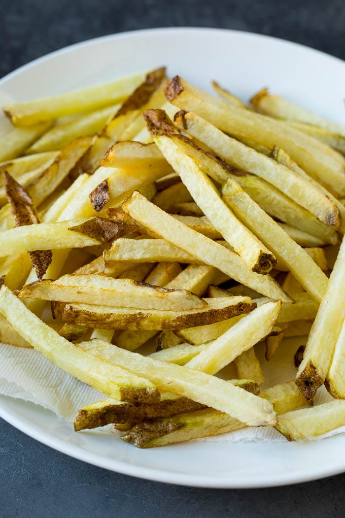 Homemade French Fries Recipe #potatoes #fries #dinner #ezlod Par-fried potatoes on a plate.