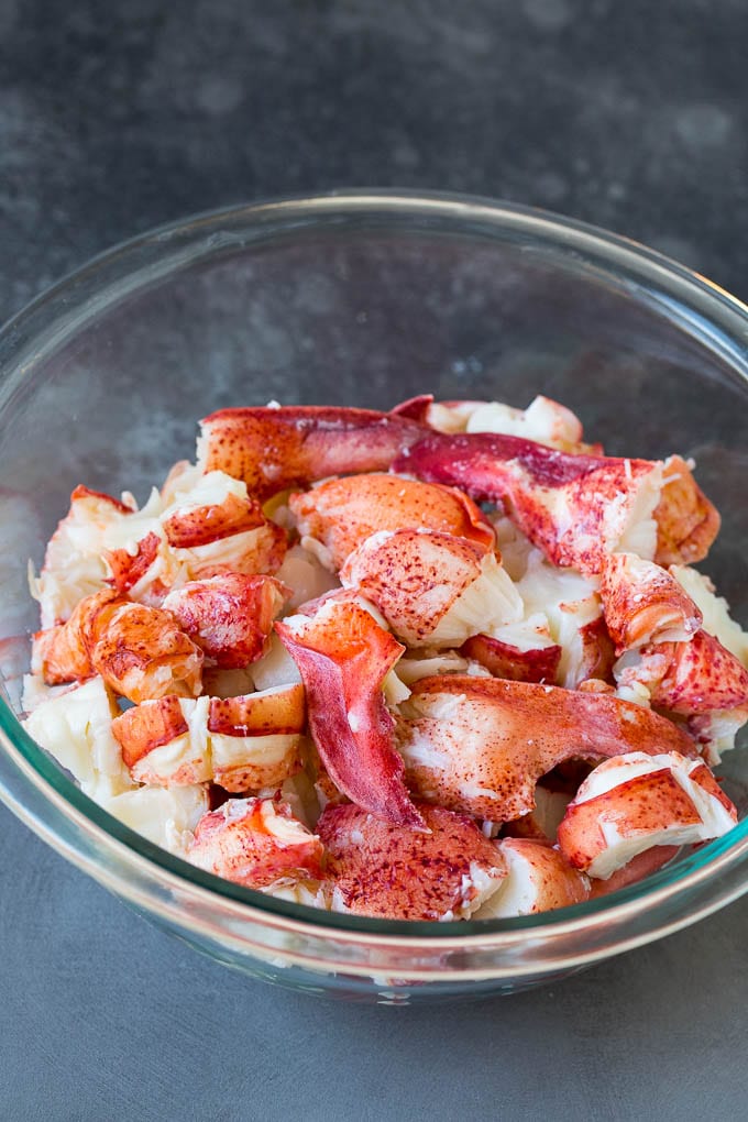 Lobster rolls stuffed with creamy lobster salad in a toasted bun. #lobster #ezlod Chunks of lobster meat in a bowl.