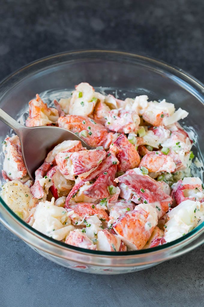 Lobster rolls stuffed with creamy lobster salad in a toasted bun. #lobster #ezlod Lobster salad in a bowl in a creamy dressing.