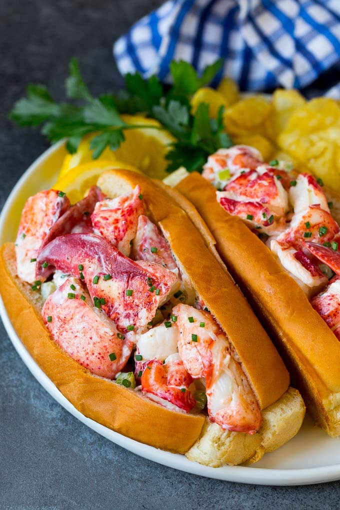 Lobster rolls stuffed with creamy lobster salad in a toasted bun. #lobster #ezlod Lobster roll with chunks of fresh lobster meat in a buttered and toasted bun.