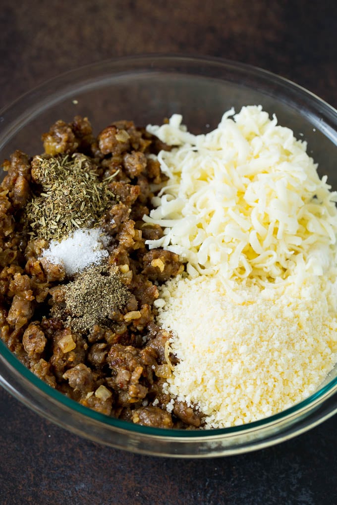 Baked Manicotti Recipe #pasta #cheese #dinner #ezlod Sausage, cheeses and herbs in a mixing bowl.