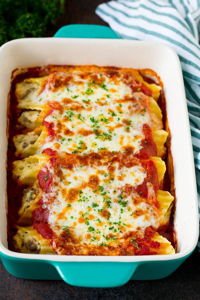 Baked Manicotti Recipe #pasta #cheese #dinner #ezlod A dish of baked manicotti pasta topped with melted cheese and parsley.