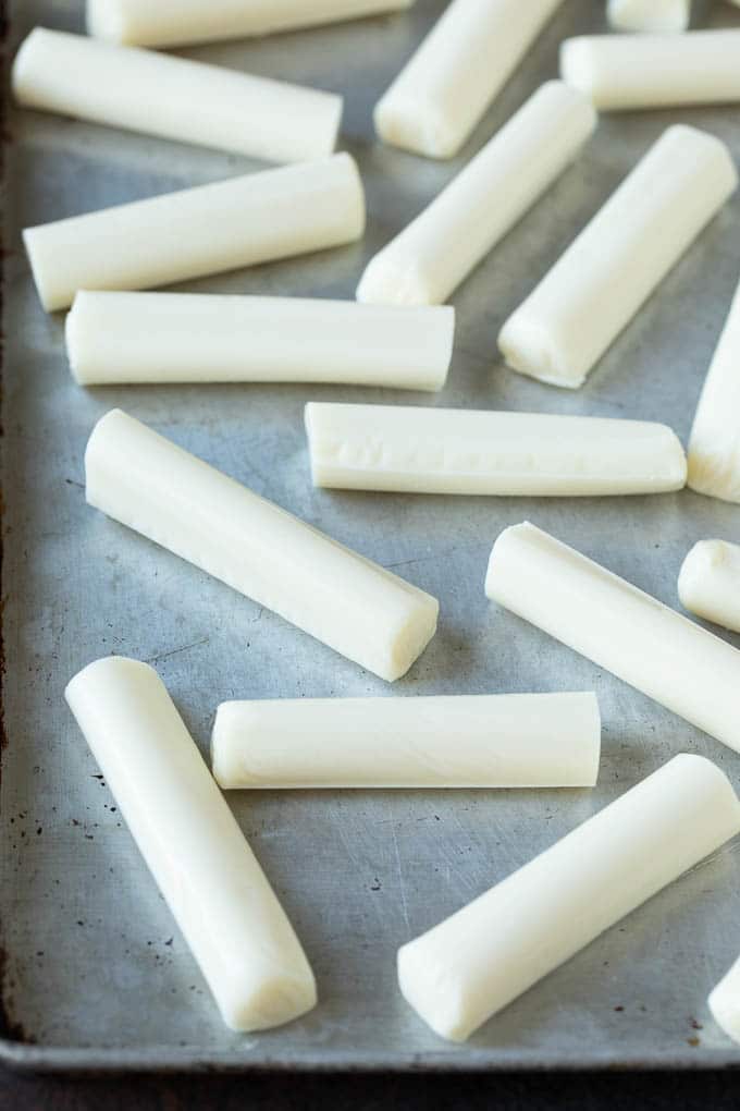 Mozzarella Sticks Recipe #cheese #appetizer #ezlod Cheese sticks on a sheet pan.