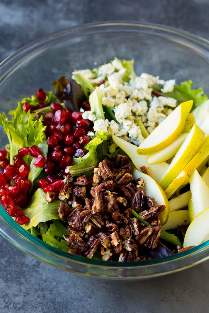 Pear Salad Recipe #salad #pears #fall #winter #dinner #ezlod Lettuce with sliced pears, blue cheese and pecans on top.