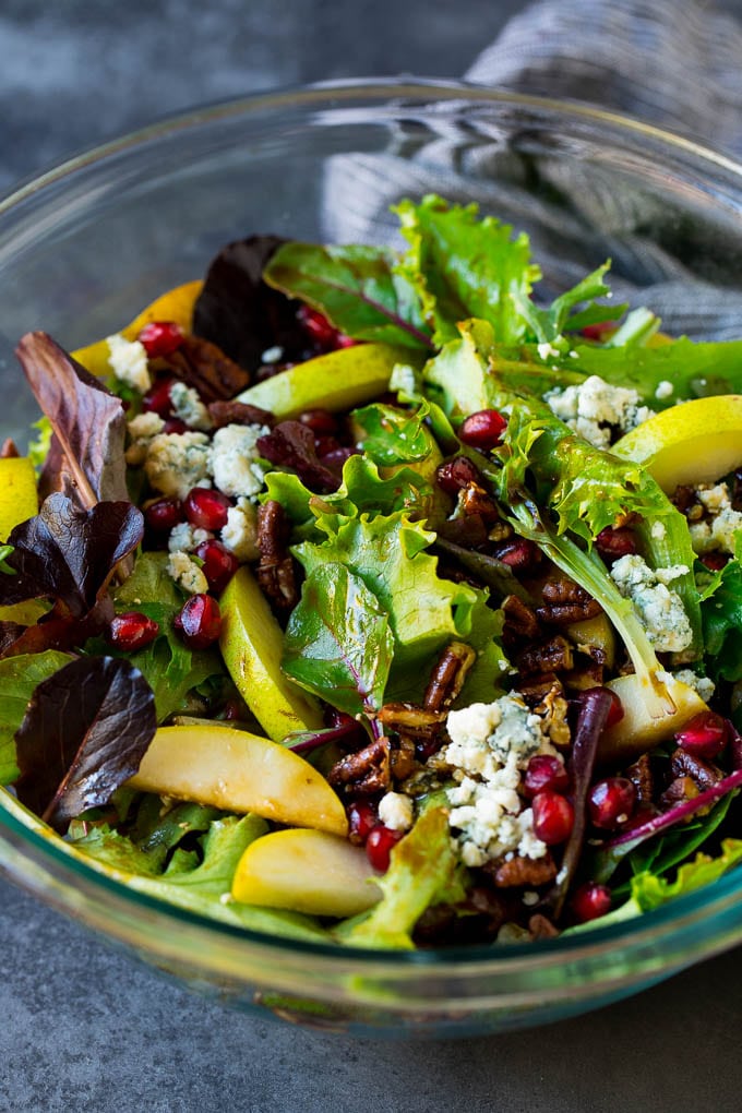 Pear Salad Recipe #salad #pears #fall #winter #dinner #ezlod A bowl of pear salad with pomegranate, blue cheese and candied pecans.