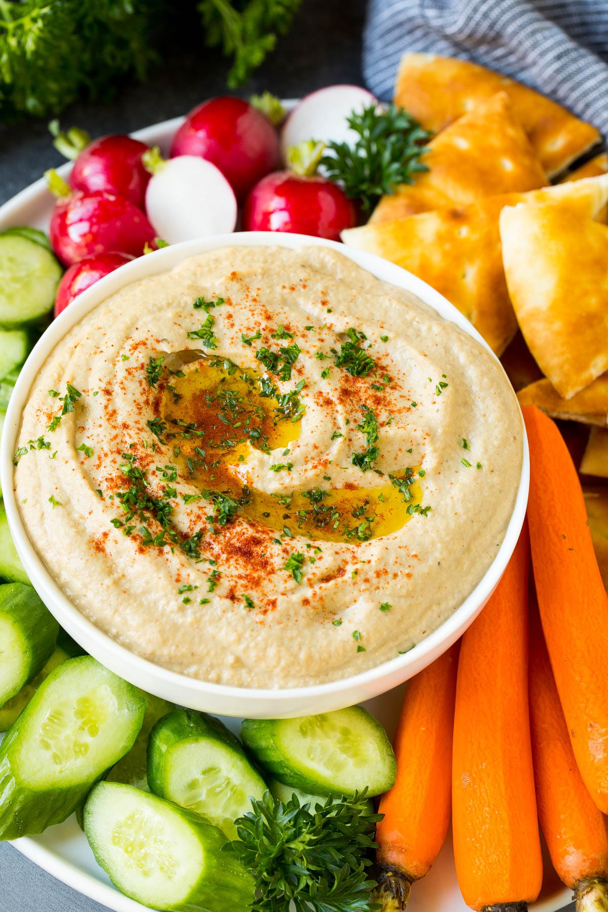 Baba Ganoush Recipe | Eggplant Dip #eggplant #appetizer #dip #healthy #glutenfree #lowcarb #ezlod Baba ganoush in a bowl surrounded by bread and vegetables.